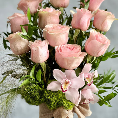 12 Pink Long Stem Roses Standing Tall arrangement with Ecuadorian long-stem roses and cymbidium orchids in a glass vase, available for same-day delivery by Santa Monica Florist.