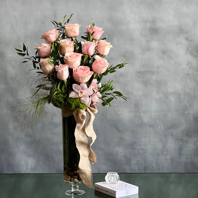 12 Pink Long Stem Roses Standing Tall arrangement with Ecuadorian long-stem roses and cymbidium orchids in a glass vase, available for same-day delivery by Santa Monica Florist.