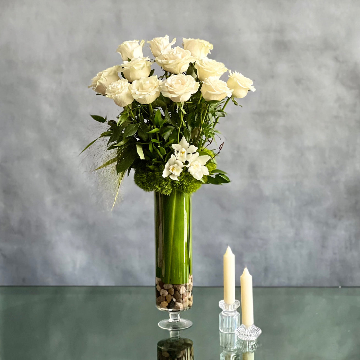 12 White Long Stem Roses Standing Tall arrangement with Ecuadorian long-stem roses and cymbidium orchids in a glass vase, available for same-day delivery by Santa Monica Florist.