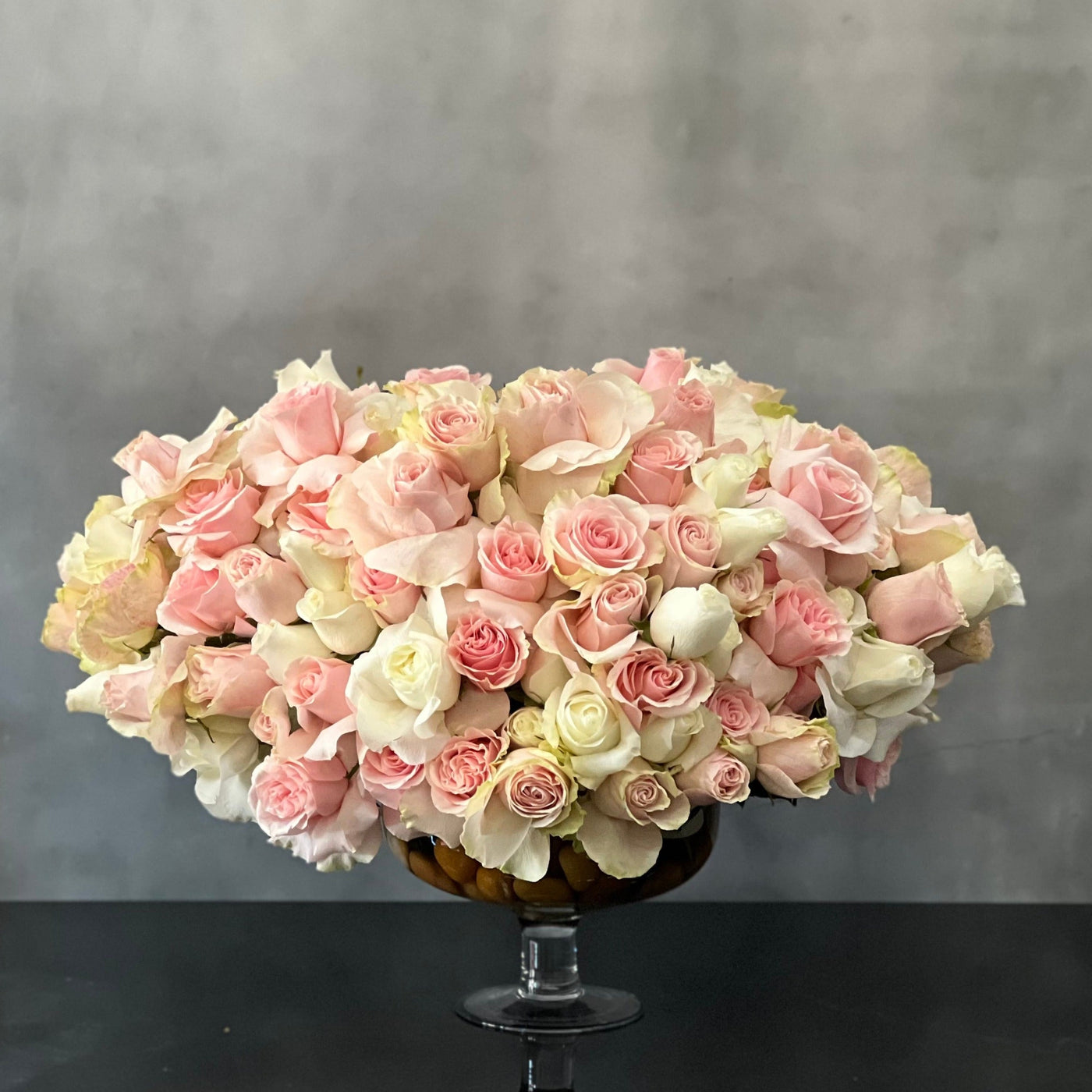 Designed to be the ultimate expression of your affection our team at Santa Monica Florist can arrange our Passion in Pink for same day delivery. In our floral piece we have over 100 stems of Light Pink and white South American Roses are exquisitely arranged in a container. This is sure to leave an impression that's impossible to forget! A notion of sincerity making it wonderful for love and romance, thinking of you, congratulations, welcomes and more ! 