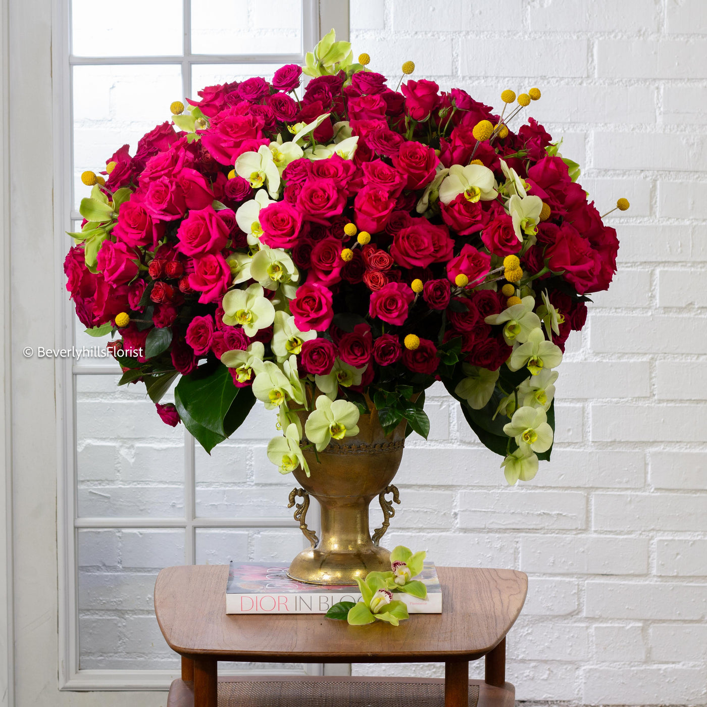 Amore Roses arrangement with red, pink, and cream roses, orchids, and spray roses in a golden pedestal container, available for same-day delivery by Santa Monica Florist.