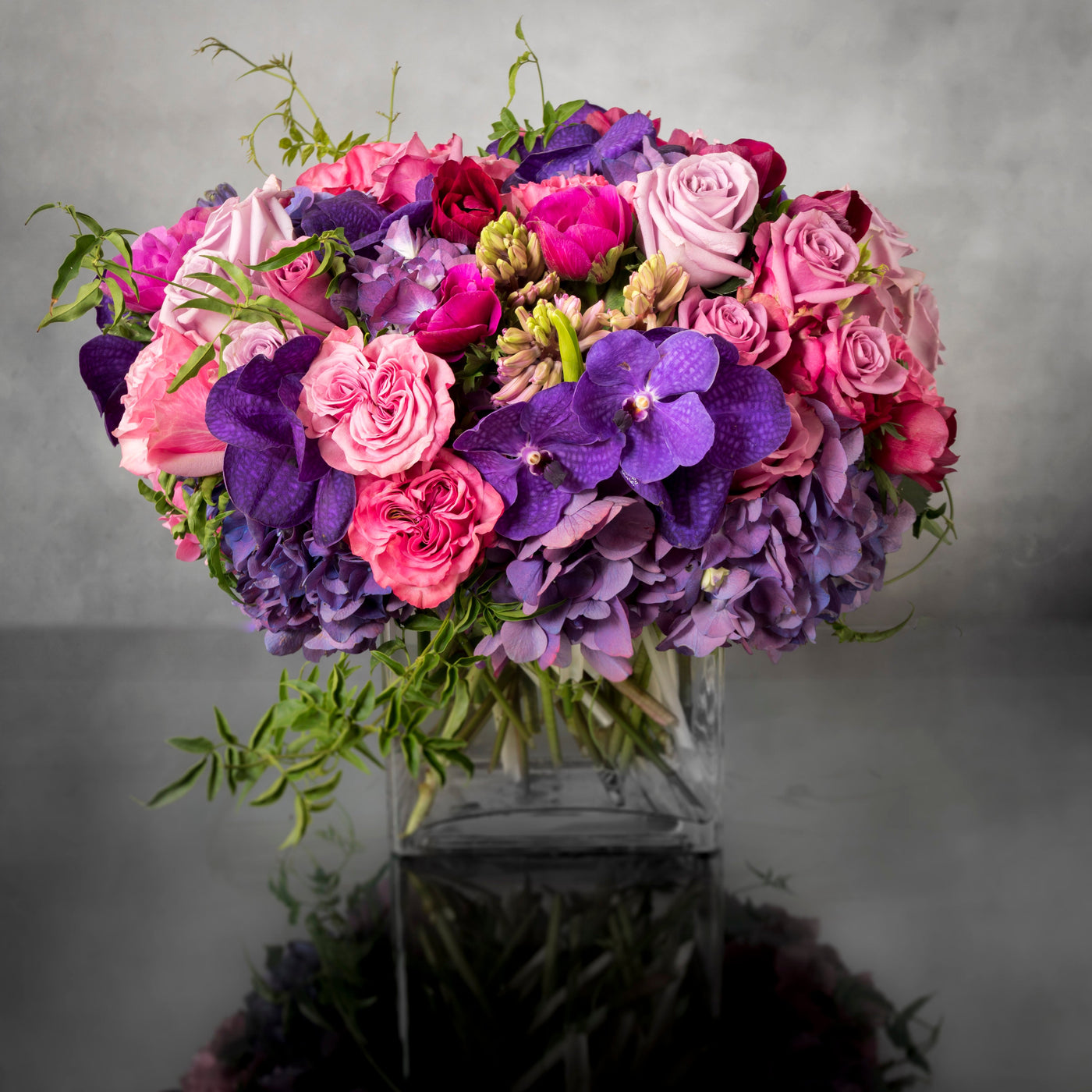 Aroma Therapy arrangement with Dutch orchids, garden roses, and hydrangeas in shades of blue, pink, and purple, available for same-day delivery by Santa Monica Florist.