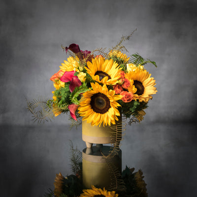 Beautiful Sunshine arrangement with sunflowers in a yellow ceramic-footed vase, available for same-day delivery by Santa Monica Florist.