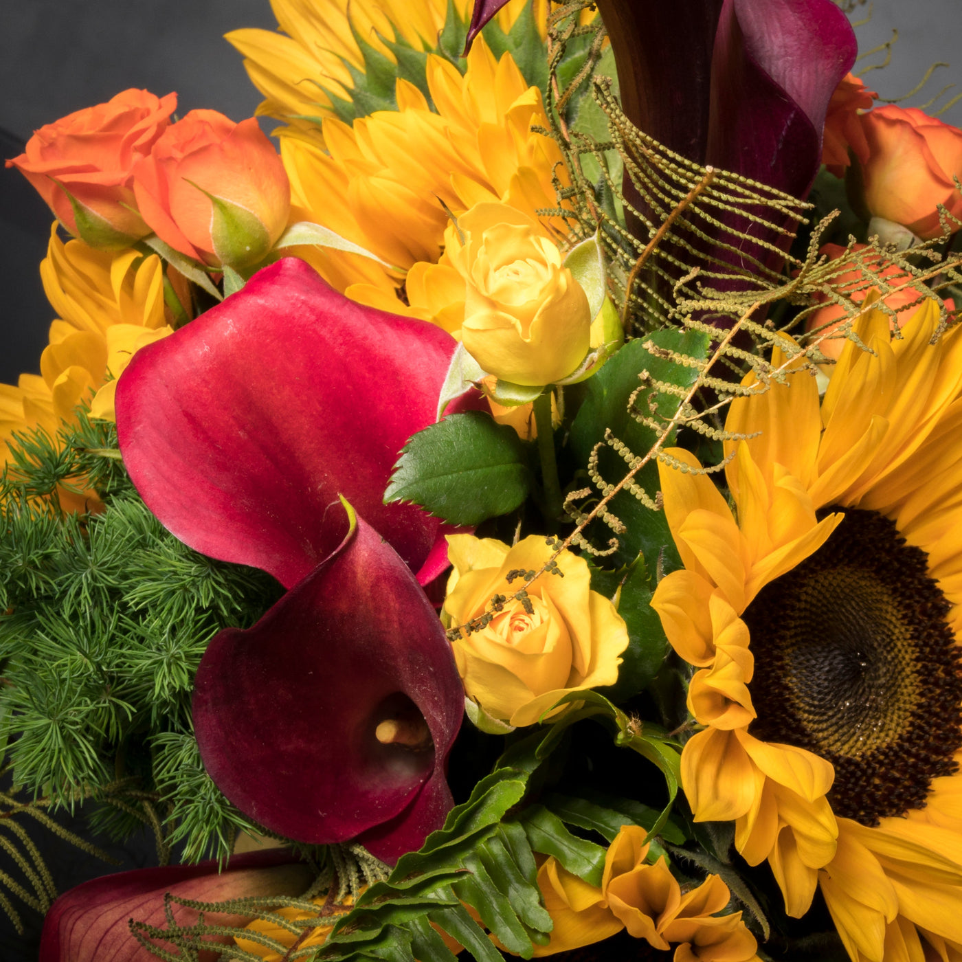 Beautiful Sunshine arrangement with sunflowers in a yellow ceramic-footed vase, available for same-day delivery by Santa Monica Florist."