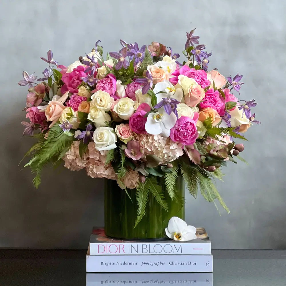 Blooming arrangement with peonies, roses, orchids, hydrangeas, and seasonal greens in a chic design, available for same-day delivery by LA Orchidia.