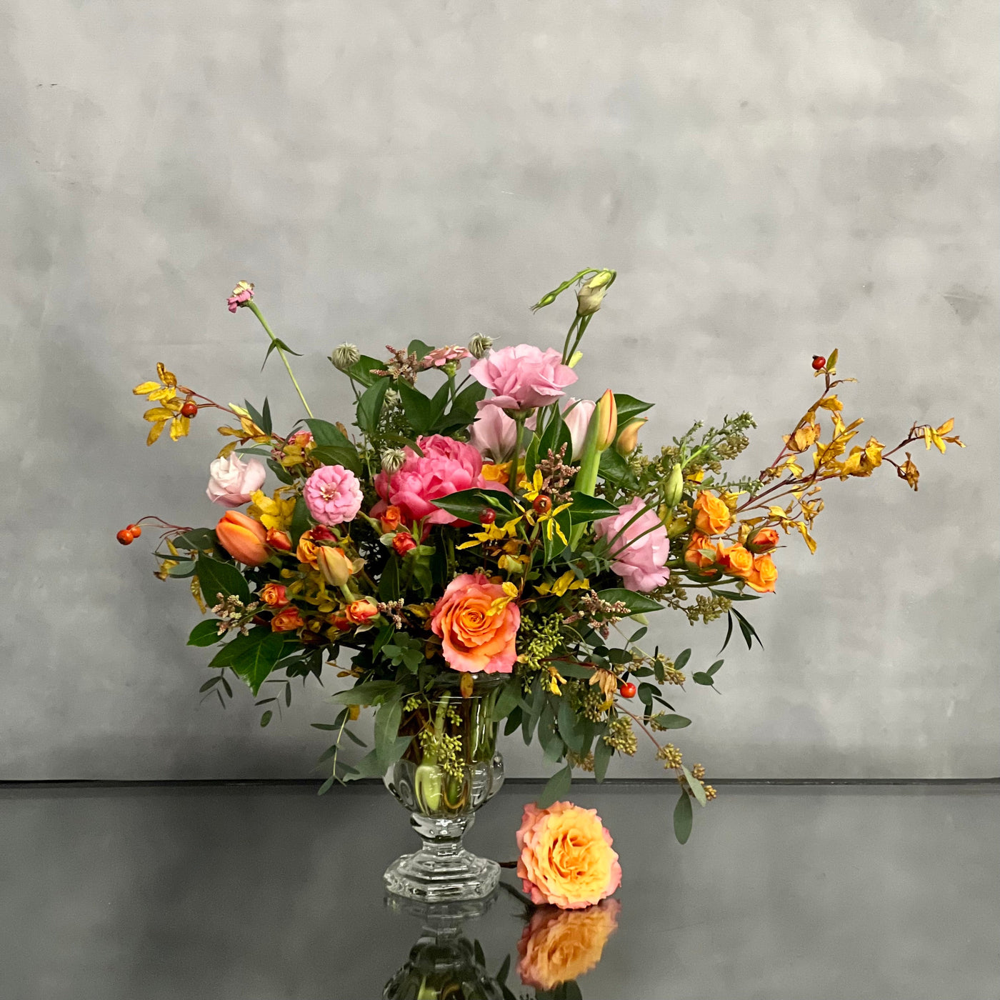 Blossoms Of The Roaring Twenties arrangement with orange garden roses, coral peonies in a vintage 20's era vase, available for same-day delivery by Santa Monica Florist.