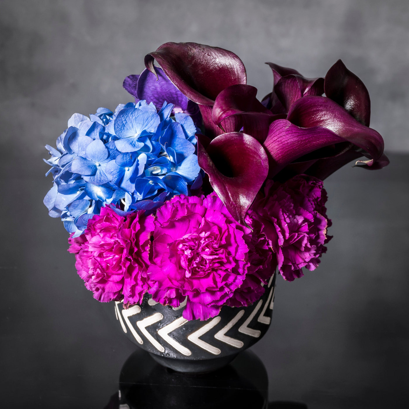 Blue Moonlight arrangement with blue, purple, and pink specialty flowers, available for same-day delivery by Santa Monica Florist.