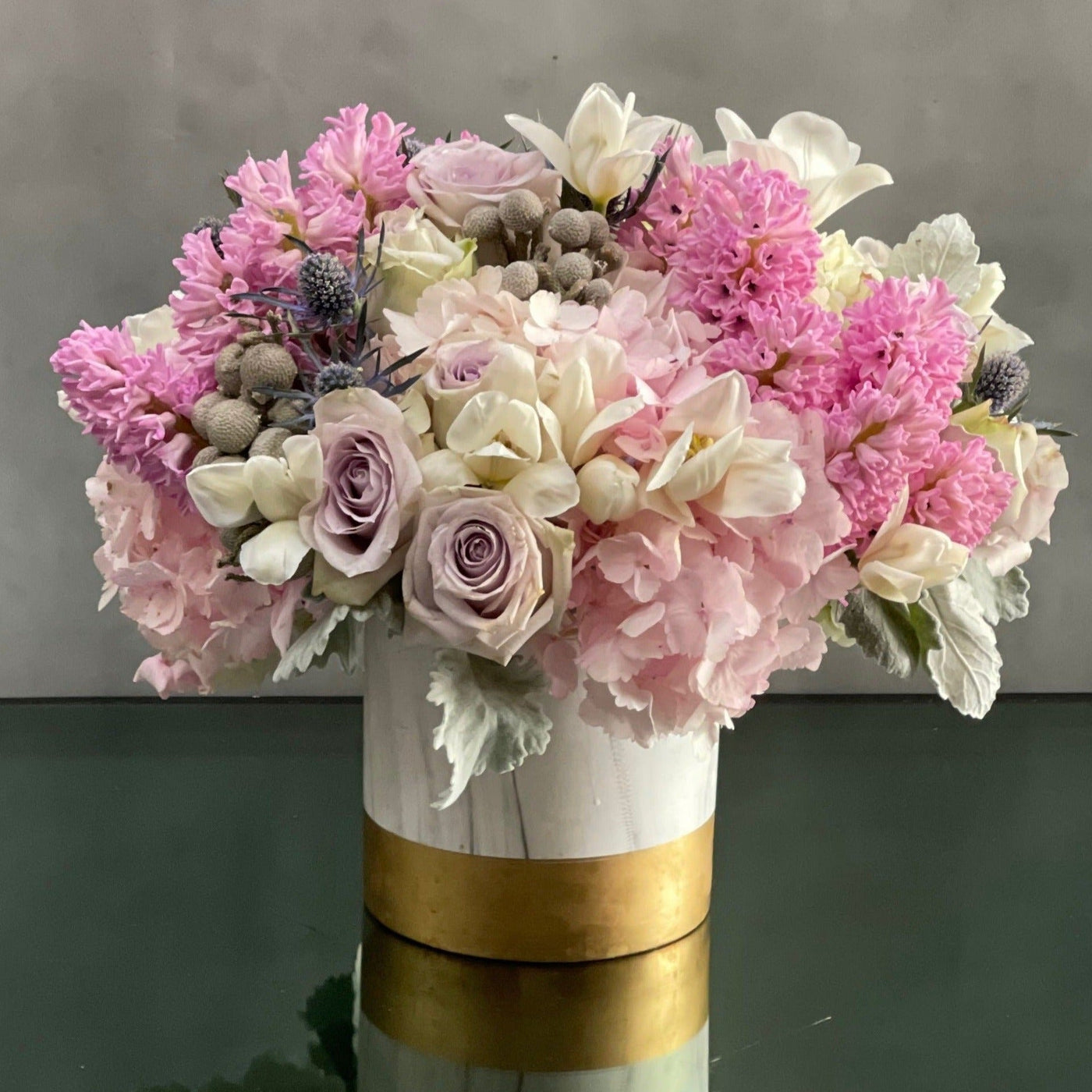 A full, fluffy, fragrant arrangement filled with lovely pastel hyacinths and lavender roses. Santa Monica Florist presents Powder puff for same day delivery ! Powder pink Hydrangeas add fullness while accent florals sprinkle in additional colors. This arrangement is perfect for everyday or a special day.