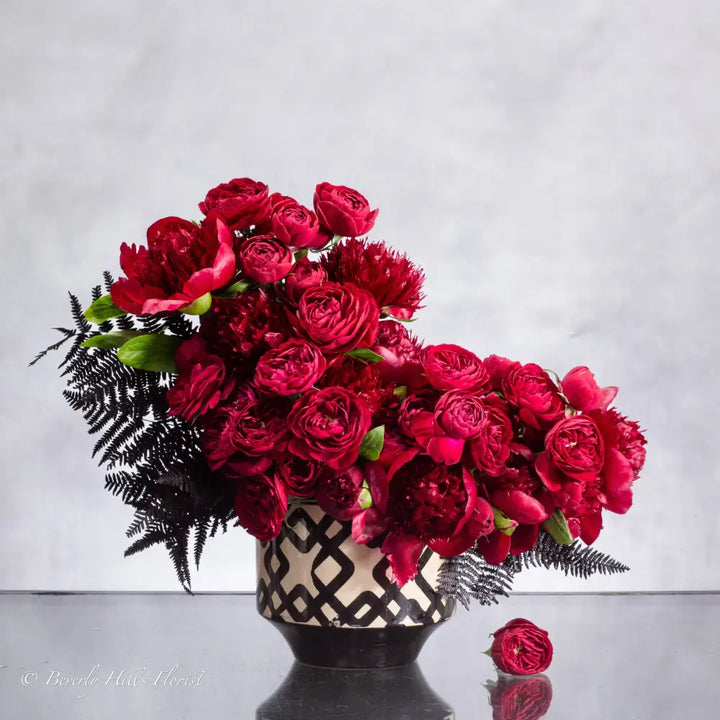 Peony Romance floral arrangement with red garden spray roses and burgundy peonies in a ceramic vase, 18 inches tall, available for same-day delivery by LA Orchidia.