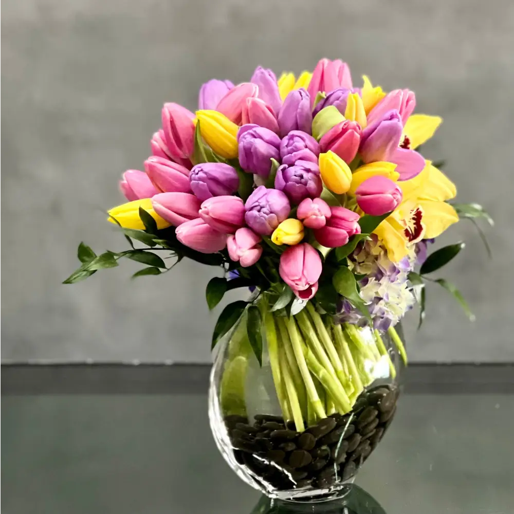 Here's a spring-tastic way to brighten someone's day from LA Orchidia. With our same day delivery arrangement placed in a glass vase of beautiful Tulips, Orchids and Hydrangeas, it makes a delightful decoration for a table, or any corner of the home office that could use a little magic.