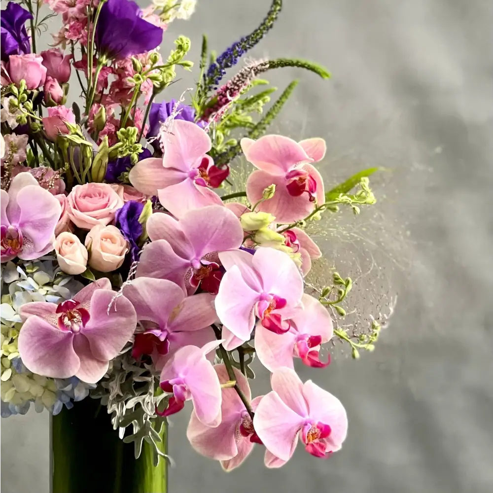 LA Orchidia presents same day delivery for our "Liberty" arrangement. Our team has put together a beautiful land vast floral piece that includes various flowers. These flowers are Hydrangeas, Orchids, Dusty Miller and more. Beautifully pieced for a Birthday, Thinking of You, Thank you, Love and Romance and more.