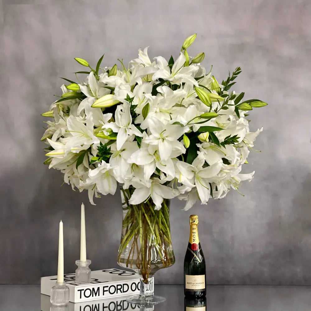 Tall long stem Casablanca lilies arranged in a glass vase with same-day delivery in Los Angeles