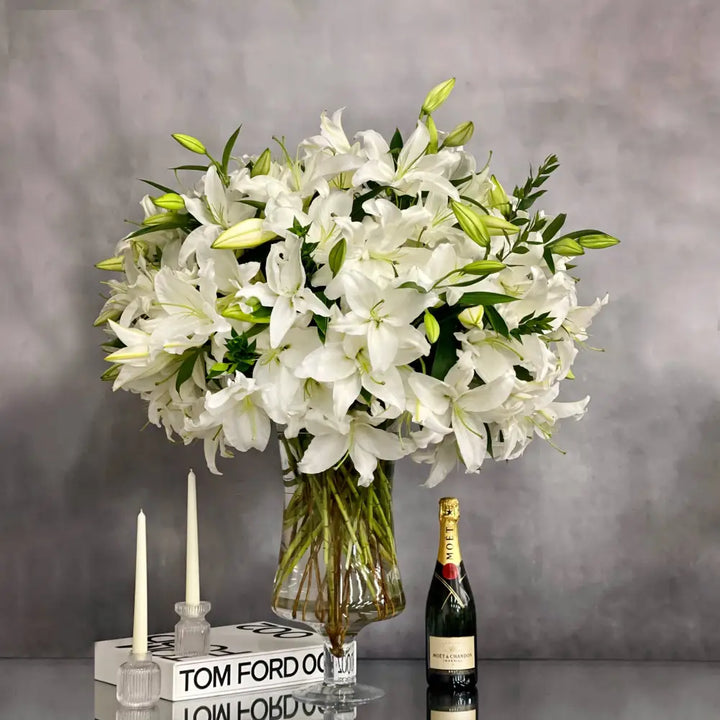 Tall long stem Casablanca lilies arranged in a glass vase with same-day delivery in Los Angeles