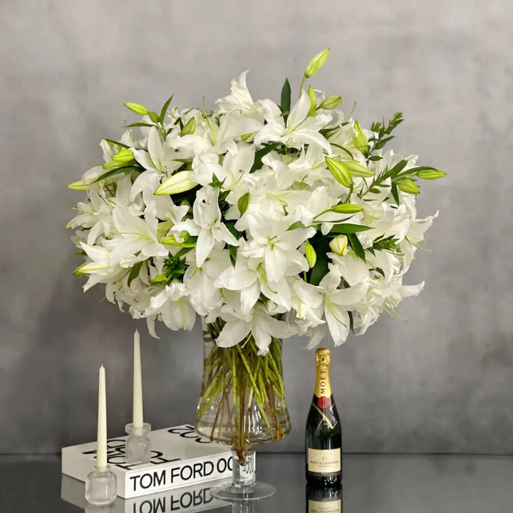 Tall long stem Casablanca lilies arranged in a glass vase with same-day delivery in Los Angeles