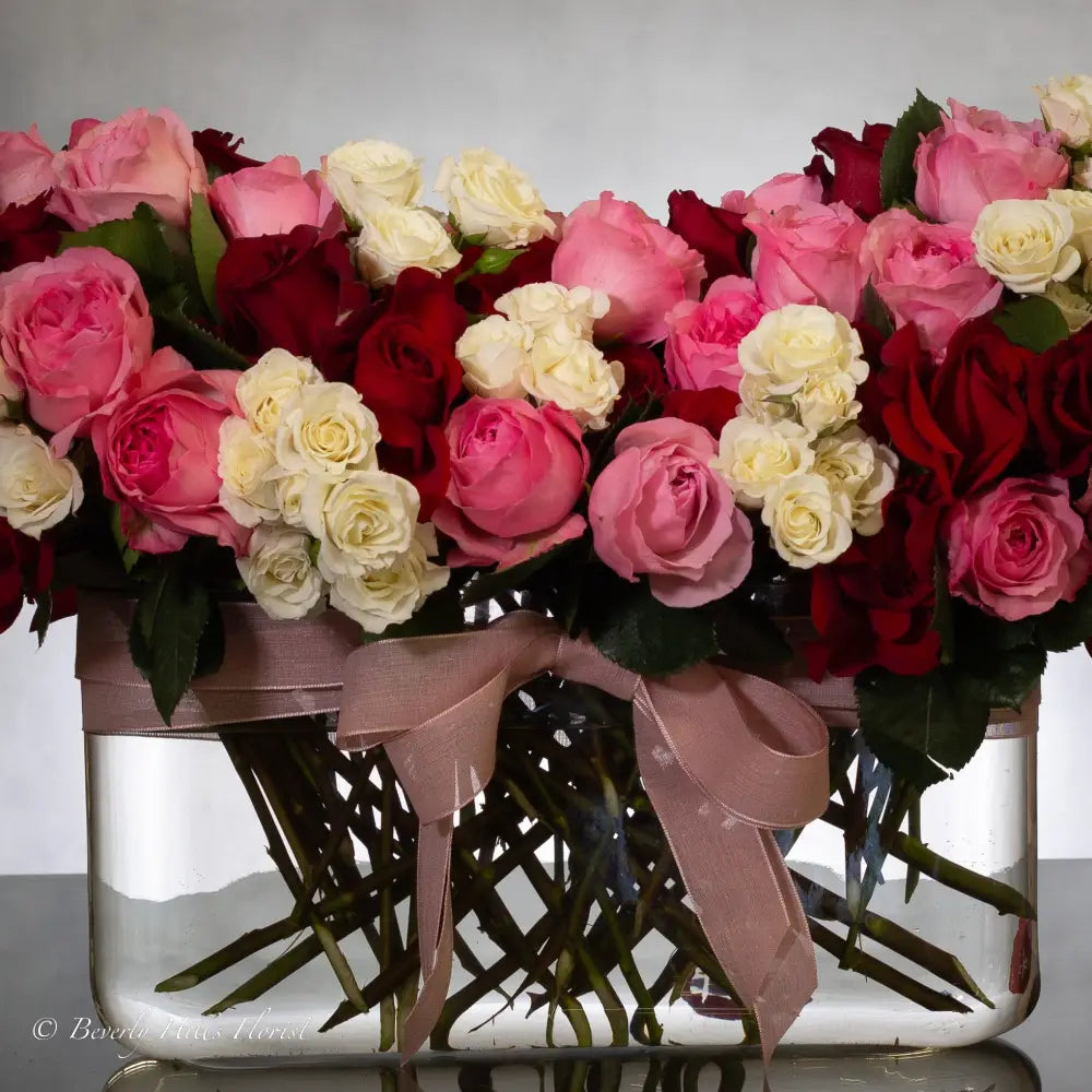 Luxury heart-shaped rose arrangement with over 100 premium red roses in a glass vase, available for same-day delivery in Los Angeles and Los Angeles.