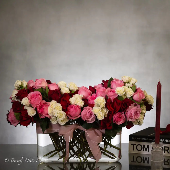Luxury heart-shaped rose arrangement with over 100 premium red roses in a glass vase, available for same-day delivery in Santa Monica and Los Angeles.