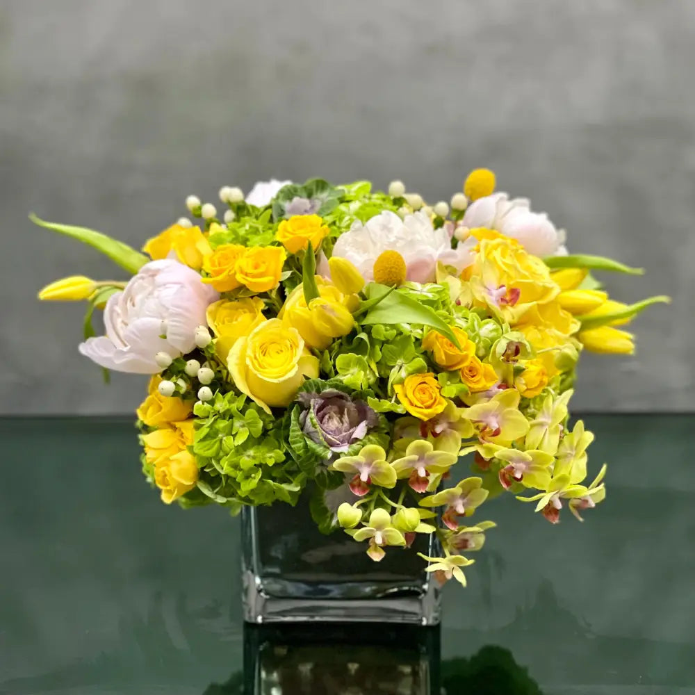 LA Orchidia presents Mellow Yellow for same day delivery! Includes, Yellow Roses, White and light pink Peonies, Green Hydrangeas, Baby  Orchids, cabbage, yellow Tulips and seasonal berries 