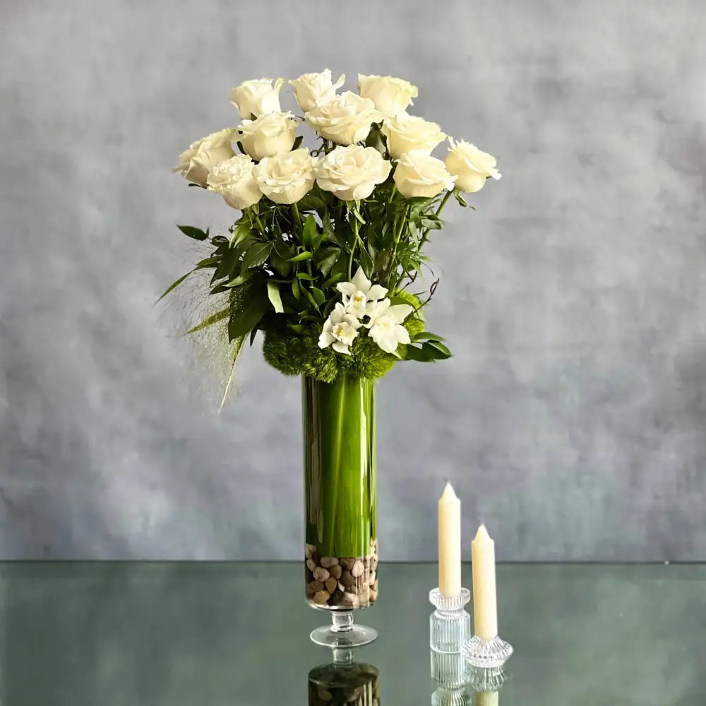12 White Long Stem Roses Standing Tall arrangement with Ecuadorian long-stem roses and cymbidium orchids in a glass vase, available for same-day delivery by LA Orchidia.