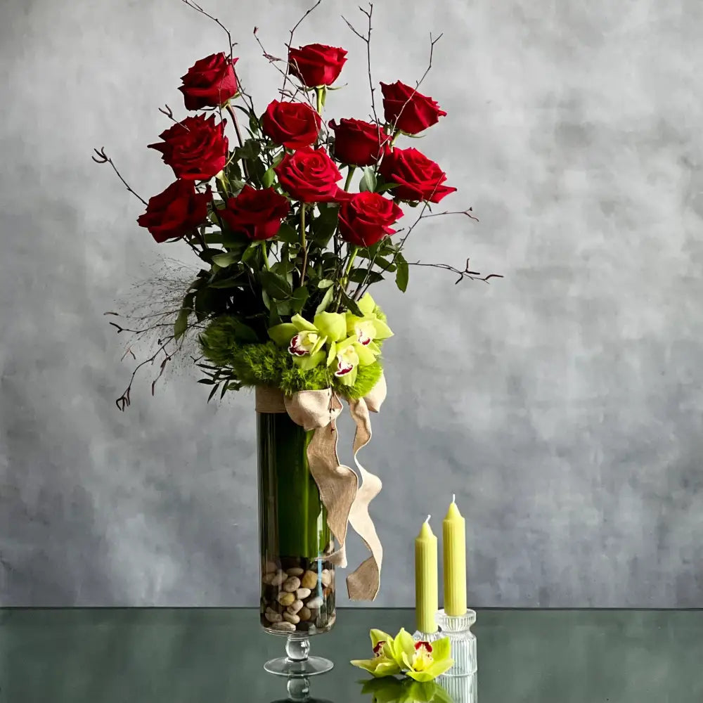 12 Roses Standing Tall arrangement with Ecuadorian long-stem roses and cymbidium orchids in a glass vase, available for same-day delivery by LA Orchidia.