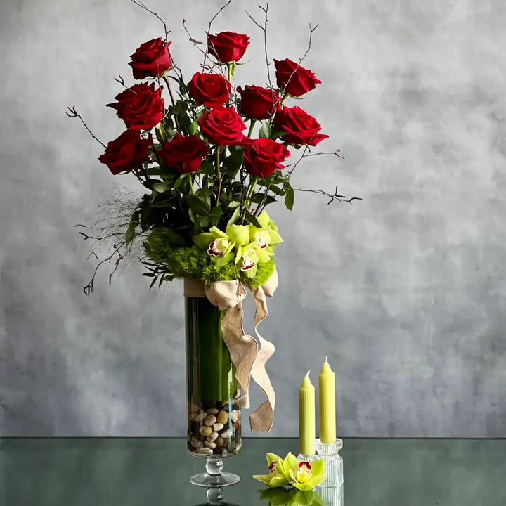 12 Roses Standing Tall arrangement with Ecuadorian long-stem roses and cymbidium orchids in a glass vase, available for same-day delivery by LA Orchidia.