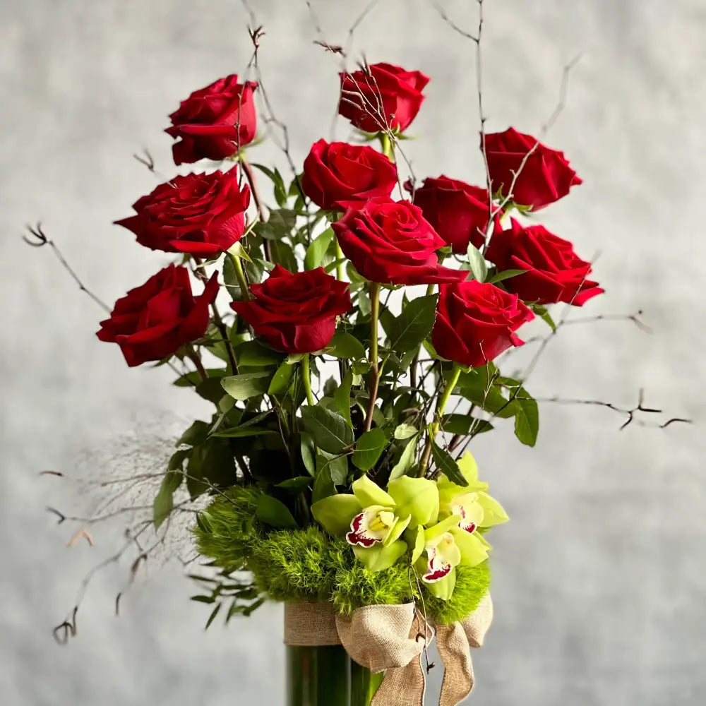 12 Roses Standing Tall arrangement with Ecuadorian long-stem roses and cymbidium orchids in a glass vase, available for same-day delivery by LA Orchidia.