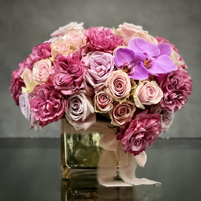 Vintage Pinks arrangement featuring 50 pink roses with orchid accents in a gold mirrored vase, available for same-day delivery by Santa Monica Florist.