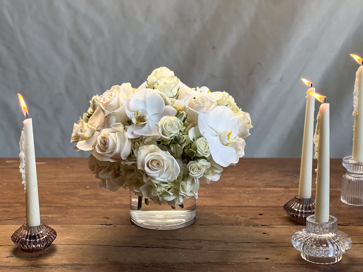 Elegant white roses and orchids arrangement in a glass vase, Santa Monica Florist.