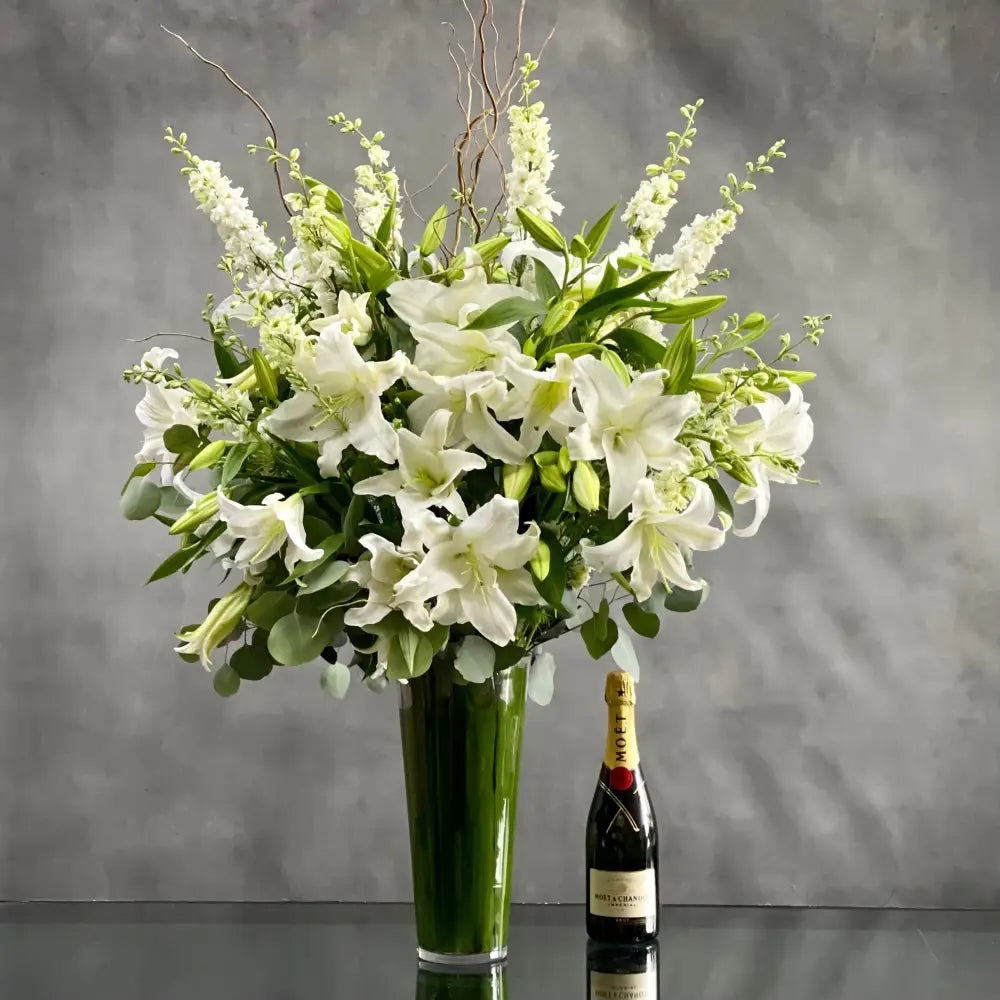 This Display of over 20 Stems of Crystal White Lily's accented with locally Grown Flowers and Greens is available for same day Delivery at LA Orchidia. This Bouquet is placed in a leaf lined 14" Tall vase with an opening of 5" and it is Approx. 45" Tall and 32 Wide. Birthday Flowers, Just because flowers, thinking of you flowers